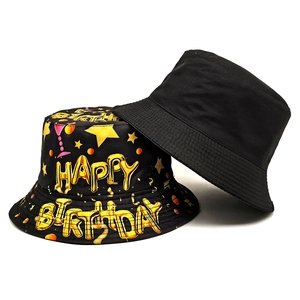 Black canvas bucket hats featuring gold Happy Birthday lettering and cocktail patterns