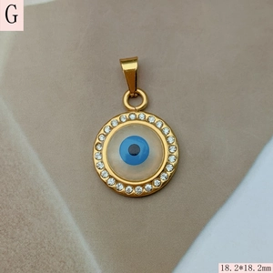 Macro view of 18.2mm golden evil eye pendant with blue enamel and pavé zircon stones