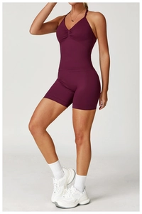 Detail of high-waisted burgundy yoga shorts and V-neck tank top fitness set for women