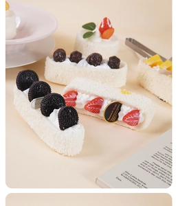 Detail of cream cake model with realistic strawberry and Oreo-style cookie toppings