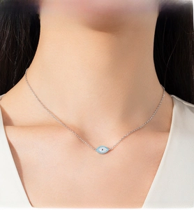 Close-up of S925 silver Evil Eye necklace with turquoise and crystals on a female model
