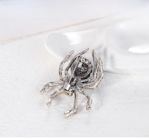 Macro shot of spider brooch back showing vintage silver metal and secure safety pin clasp