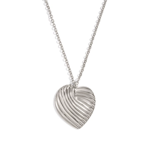 Macro shot of silver heart necklace with textured surface on a white background
