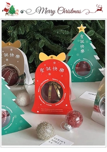 Close-up of Christmas gift boxes with tree shape and transparent window for candies