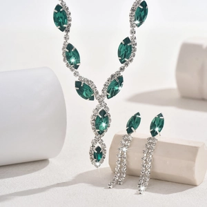 Macro shot of green marquise crystal bridal jewelry set with necklace and tassel earrings