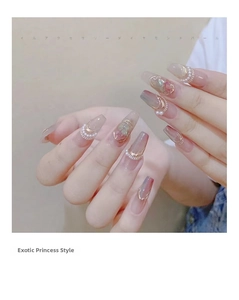 Detailed view of long coffin press-on nails with pearls, gold wires and pink crystals