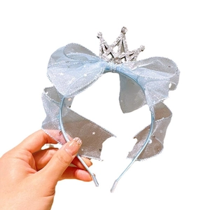 Light blue princess headband with a large tulle bow, rhinestone crown, and star patterns