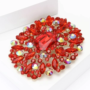 Elegant gold alloy brooch featuring large rectangular red glass and sparkling rhinestones
