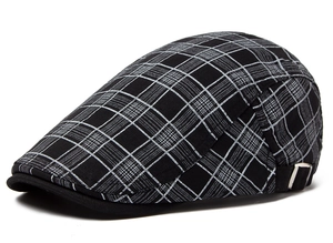 Detail view of the black plaid beret hat with a side metal adjustment buckle closure