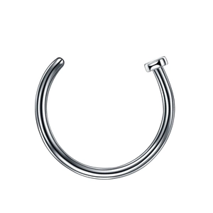 Macro shot of silver C-shaped nose ring with flat disc end in polished stainless steel