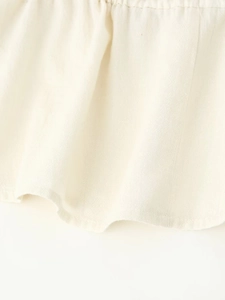 Detailed macro view of beige cotton linen fabric texture with fine stitching on hem