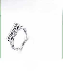 Macro shot of vintage S925 silver bow ring with cubic zirconia inlay and 1.7cm height