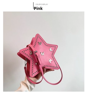 Detail of pink star-shaped crossbody bag with silver butterfly patches and metal rivets