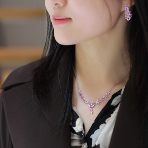 Detail of luxury butterfly necklace set with pink stones and micro-pave crystals