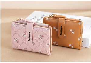 Detail view of pink and brown women short wallets with floral patterns and diamond quilting