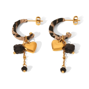 Detail of vintage leopard print C-hoop earrings with gold heart charms and black beads