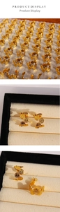 Close-up of vintage Roman coin relief earrings in C-shaped gold plated design