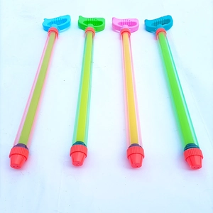 Close-up of four colorful plastic pull-out water guns for kids in a vertical row