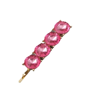 Elegant gold hair clip with four round pink crystals on a clean white background