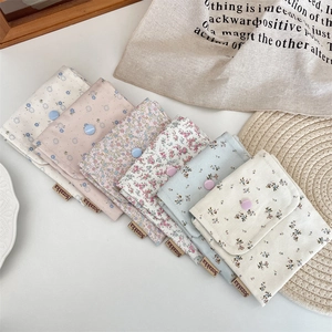 Detailed view of six floral fabric pouches with snap buttons for small items