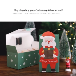 Close-up of Christmas gift box with Santa Claus design and white snowflake pattern detail