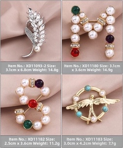 Detail view of pearl and gemstone brooches with gold and silver plating on satin fabric