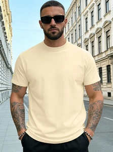 Outdoor shot of men's cream jersey t-shirt showing fit and fabric drape in city street