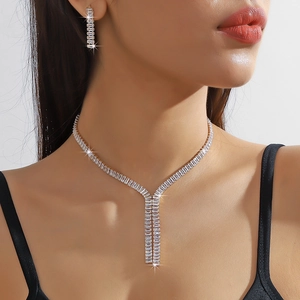 Detailed view of silver-tone Y-necklace and drop earrings set with pavé cubic zirconia