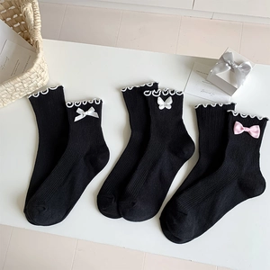 Three pairs of black JK style socks with lace ruffles and satin bow decorations