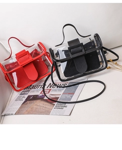 Detail view of transparent PVC crossbody bag with red and black leather inner pouches