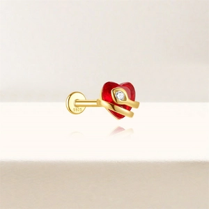 Close-up of S925 silver gold earring with red heart gemstone and snake detail