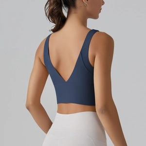 Detail of V-back yoga sports bra showing seamless design and elastic fabric on model