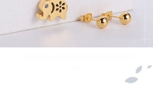 Detailed view of hollow elephant pendant and ball earrings in 18K gold-plated finish