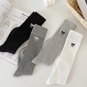 Set of four cotton calf socks with embroidered bows in black, grey, and white