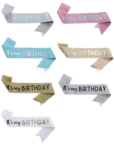 Close-up of glitter birthday sashes in various colors with It's my Birthday text