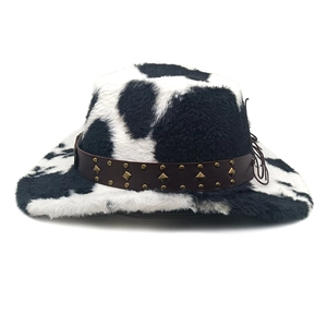 Detail of cow print cowboy hat with plush texture and studded brown leather band