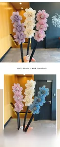 Macro detail of multi-layered organza flower hair pins with three blossoms on black rods
