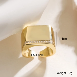 Close-up of a chunky 18K gold-plated signet ring featuring cubic zirconia accents