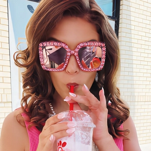Sparkly square oversized sunglasses with red floral pattern frames and reflective lenses