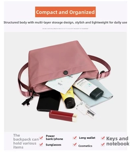 Detail showing high-capacity interior of pink crossbody bag with phone and wallet