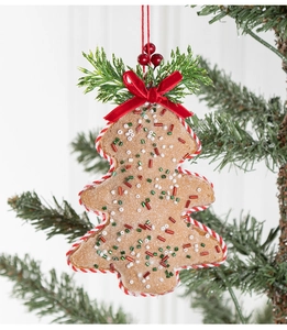 Detail of gingerbread tree ornament with red bow and frosting glitter on Christmas tree