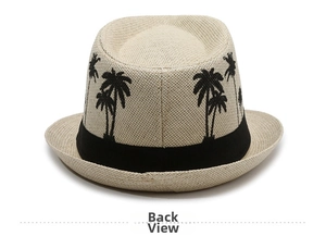 Detail view of woven beige fedora back with embroidered black palm trees and decorative ribbon
