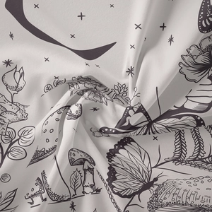 Detailed macro view of bohemian mushroom and floral pattern on soft white fabric