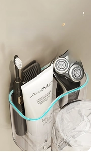 Detail view of transparent bathroom organizer for electric toothbrushes and toothpaste