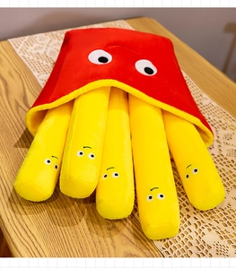 Detail of plush french fries toy featuring five cartoon sticks in a red soft fabric bag