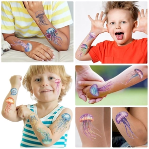 Detailed view of colorful watercolor jellyfish temporary tattoos on child's arm and hand