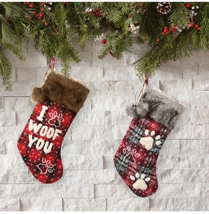 Plaid Christmas stockings with paw prints and I Woof You text on festive wall