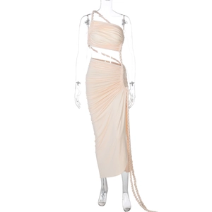 Detail view of the side cutout and pleated texture on this apricot one-shoulder dress