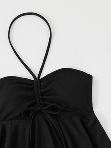 Detail of black ribbed halter bikini top with ruched drawstring and ruffled hem