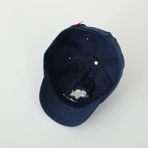 Close-up of cute elephant embroidery and red adjustable strap on navy baseball cap